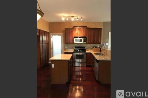 A kitchen with wooden cabinets and a central island.