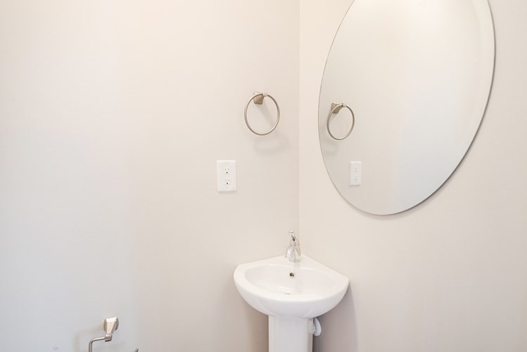 A bathroom with a sink and mirror.