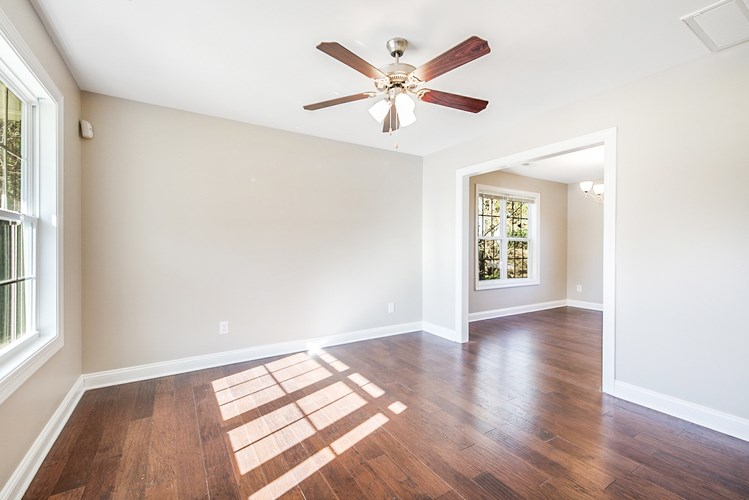 A room with a ceiling fan and a window.