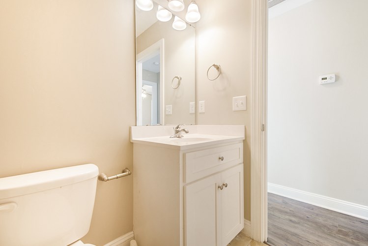 A white bathroom with a white sink and a white bathtub.