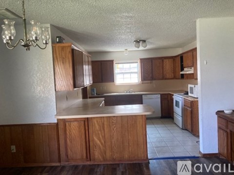 A kitchen with wooden cabinets and a white countertop.