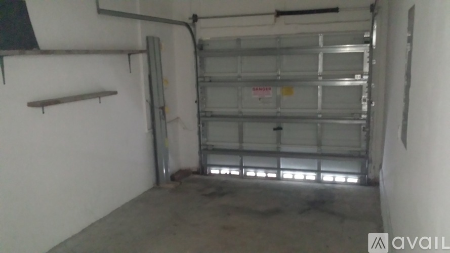 A large garage door is open to a spacious garage.