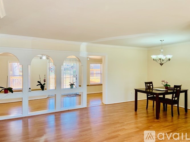 A dining room with a wooden table and chairs.