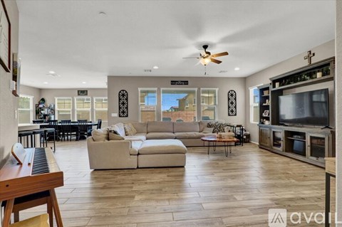 A spacious living room with a large couch and a television.