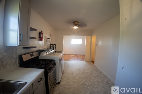 A kitchen with a stove top oven and a sink.