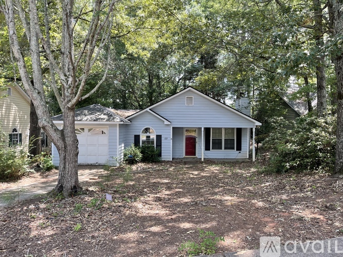 A house with a red door and an American flag on the front porch.