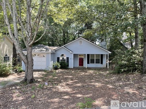 A house with a red door and an American flag on the front porch.