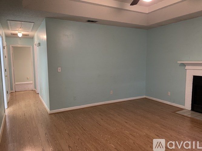 A room with light blue walls and wooden flooring.