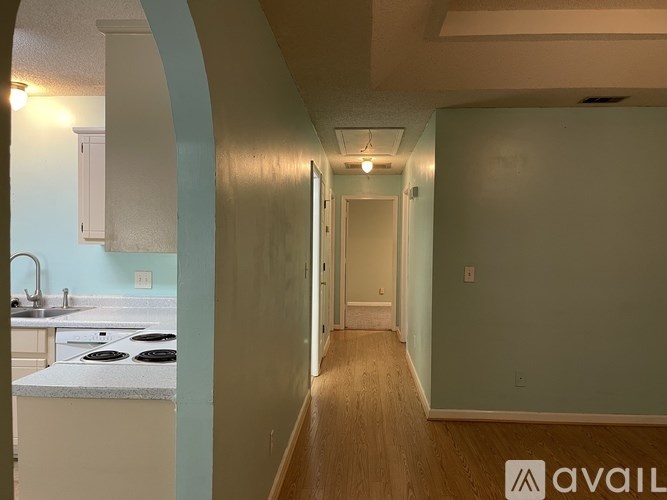 A kitchen with a stove top oven and sink.