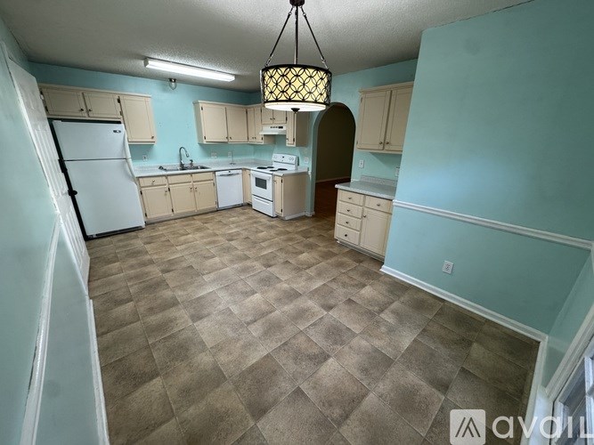 A bathroom with a toilet, sink, and a mirror.