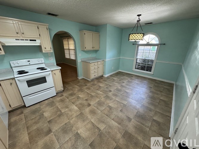 A room with a blue mat on the floor and a window with blinds.