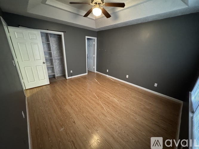 A kitchen with a white refrigerator and a checkered floor.