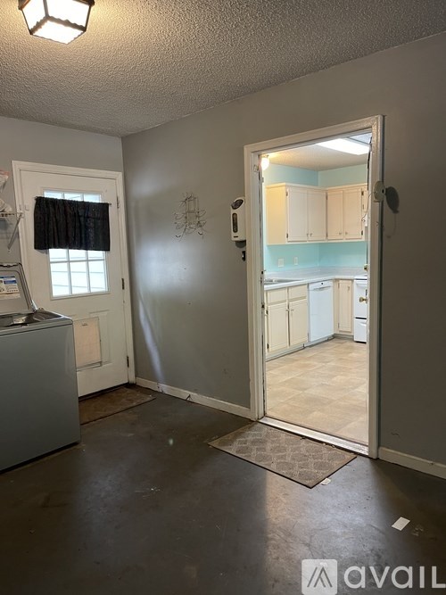 A room with a doorway leading to another room.