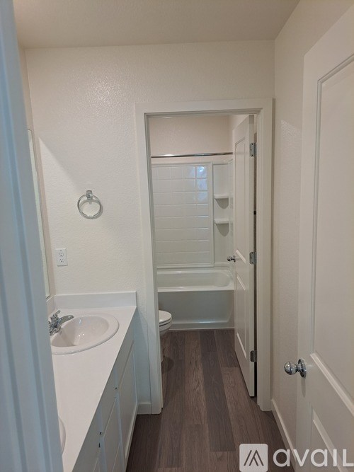 A bathroom with a toilet, sink, and bathtub.