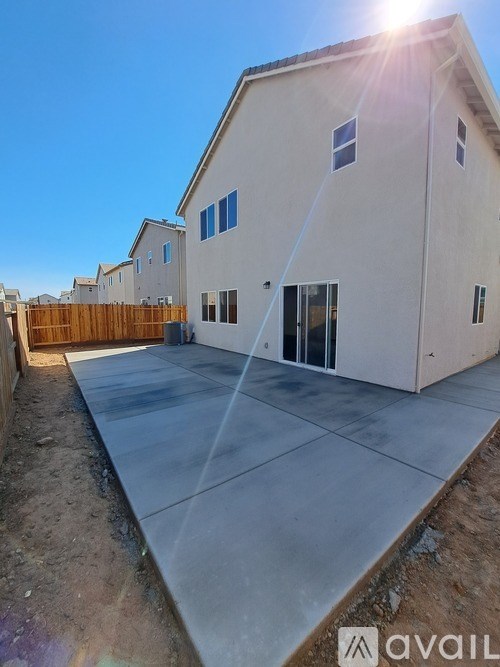 A house with a concrete driveway in front of it.