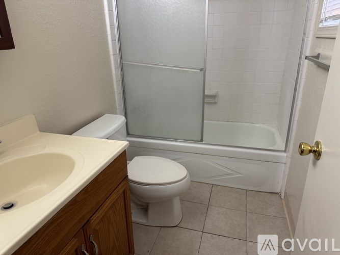 A bathroom with a toilet, sink, and shower.
