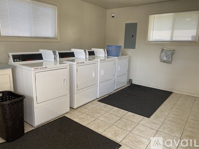 A laundry room with washers and dryers.