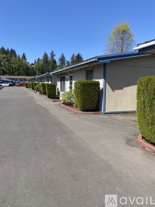 A row of houses with a driveway in front.