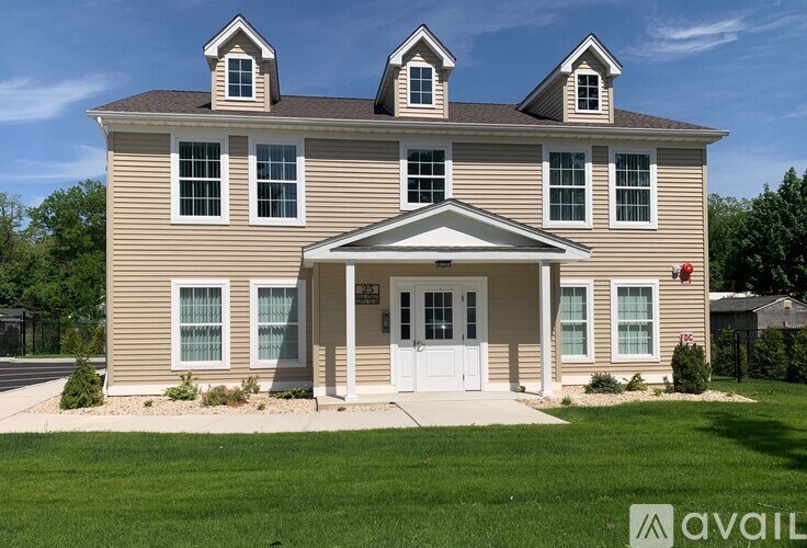 A house with a white door and windows is for sale.