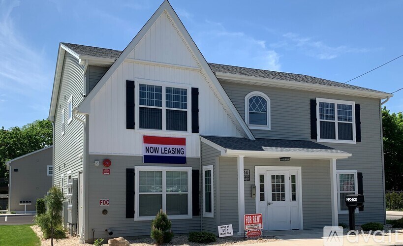 A house with a sign that says "NOW LEASING" is for sale.