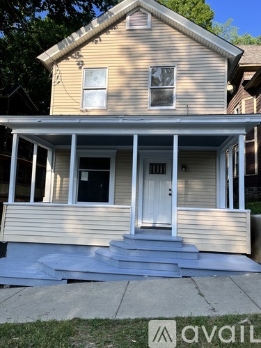A two-story house with a white door and windows.