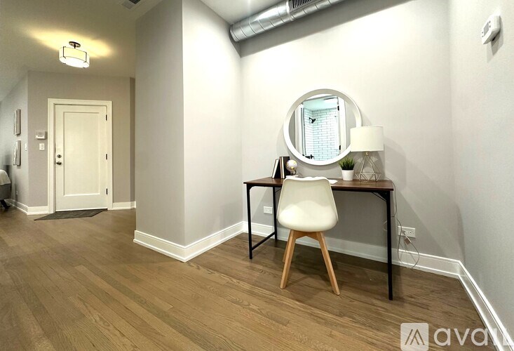 A room with a desk and chair in it.