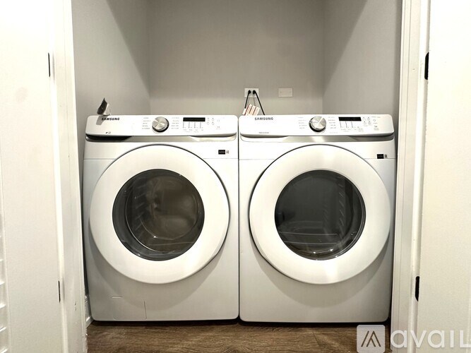 Two front loading washing machines in a laundry room.
