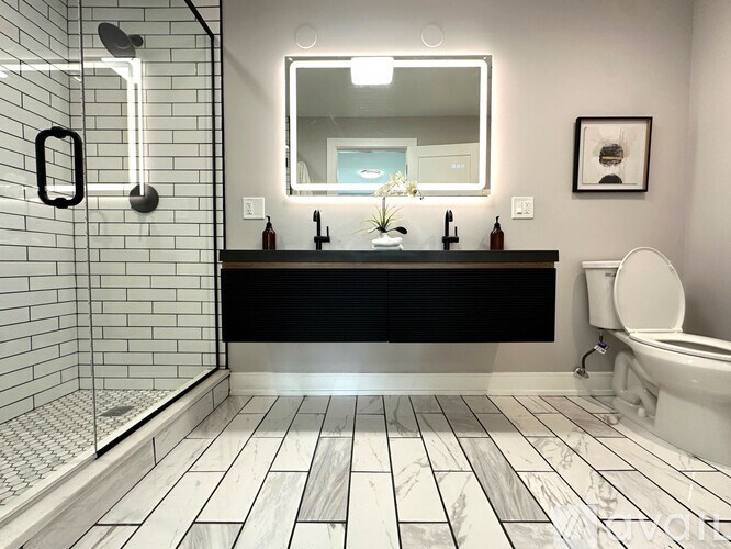 A bathroom with a black and white tile floor.