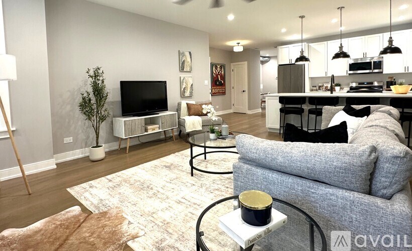 A living room with a grey couch and a white coffee table.