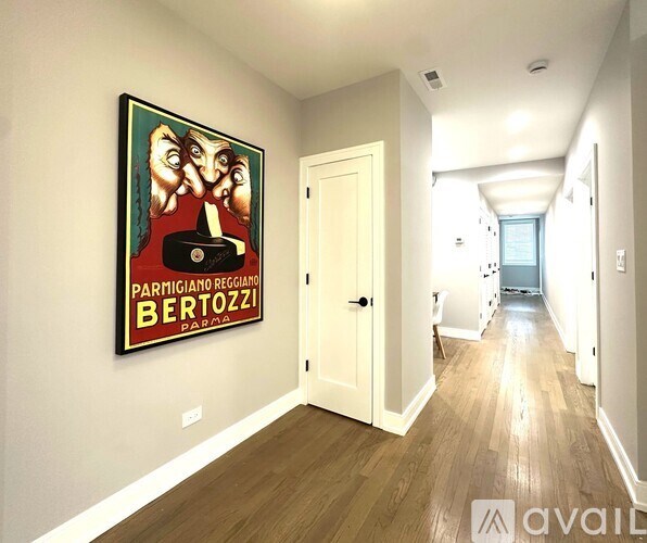 A hallway with a painting of a man's face and the words "Parmigiano Reggiano Bertozzi" on the wall.
