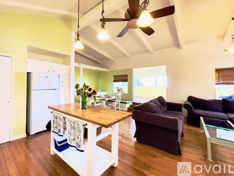 A living room with a wooden table and a couch.