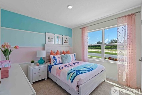 A bedroom with a white bed and a pink nightstand.