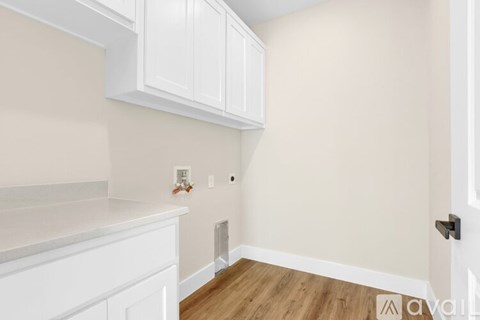 A kitchen with white cabinets and a white counter top.