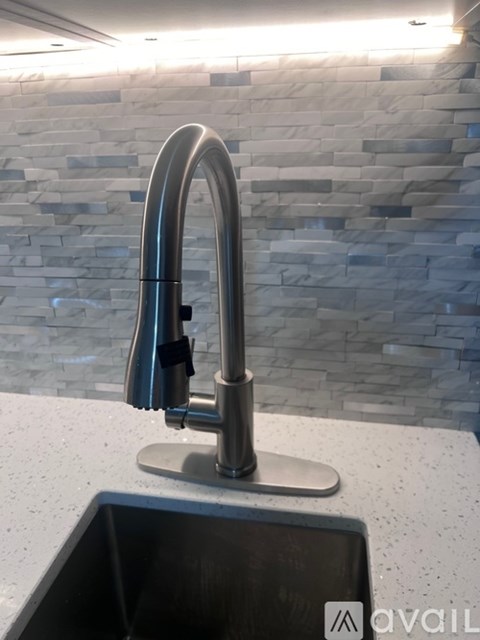 A modern kitchen sink with a chrome faucet.