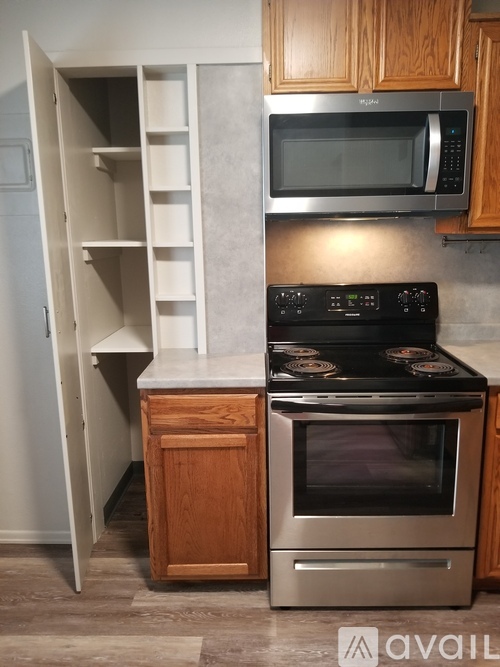 A kitchen with a stove, oven, and microwave.