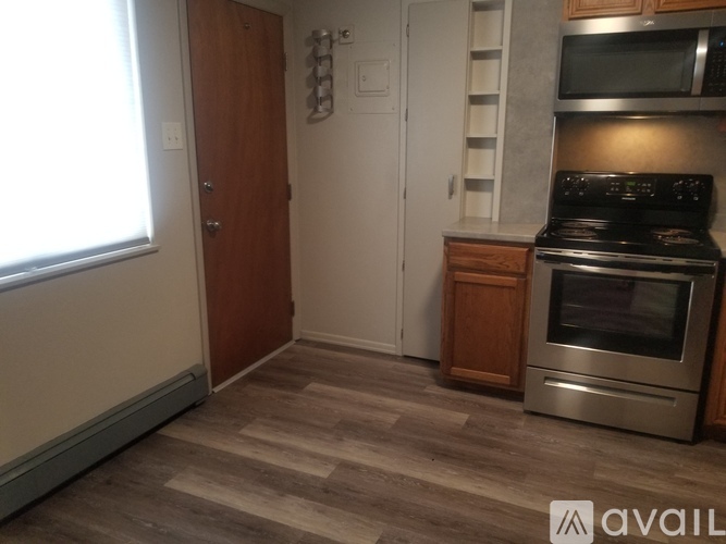 A kitchen with a stove top oven and a microwave above it.