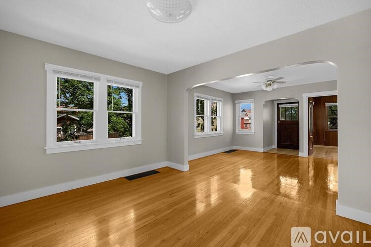 A room with wooden floors and a ceiling fan.