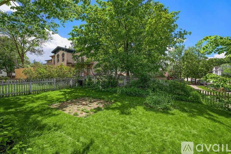 A lush green yard with a house in the background.