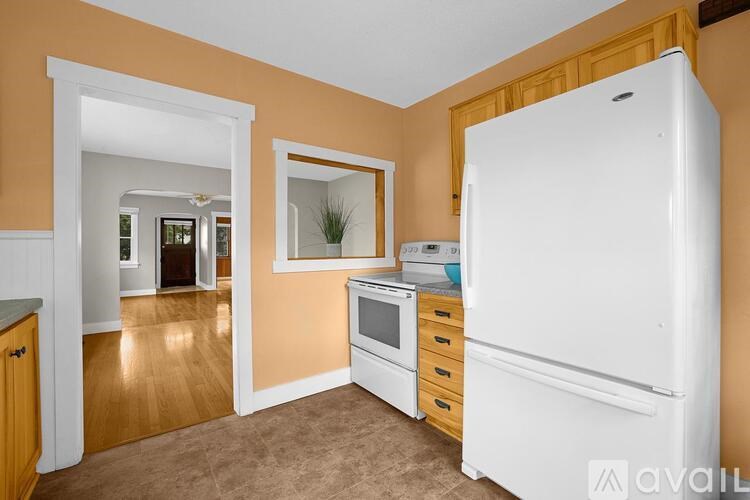 A kitchen with a white refrigerator, oven, and microwave.