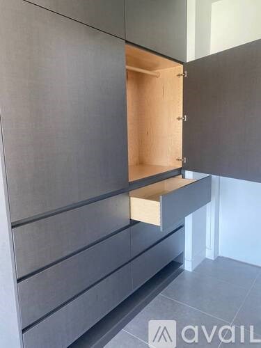 A modern kitchen with a grey cabinet and a drawer.
