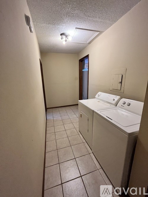 A bathroom with a white sink and tiled floor.