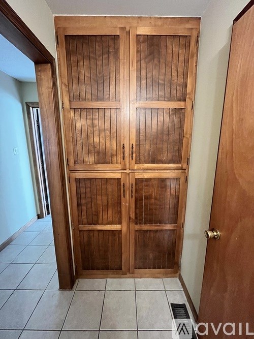 A large wooden door with a glass panel in the middle.