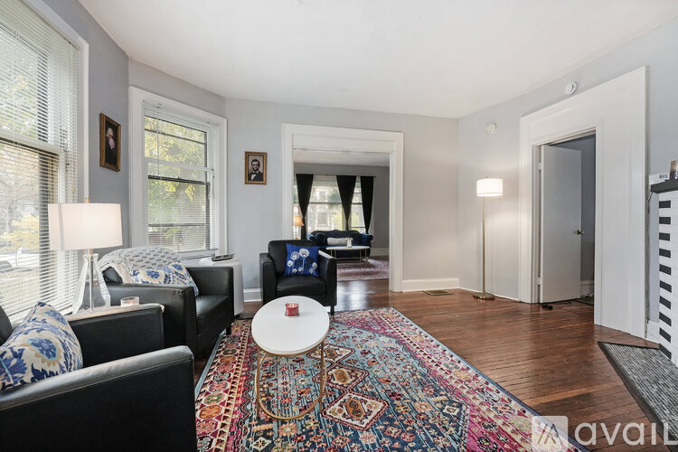 A living room with a rug and a couch.