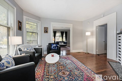 A living room with a rug and a couch.