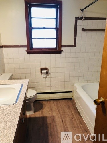 A bathroom with a toilet, sink, and bathtub.