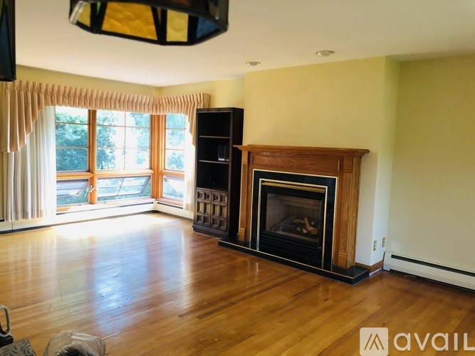 A living room with a fireplace and a television.