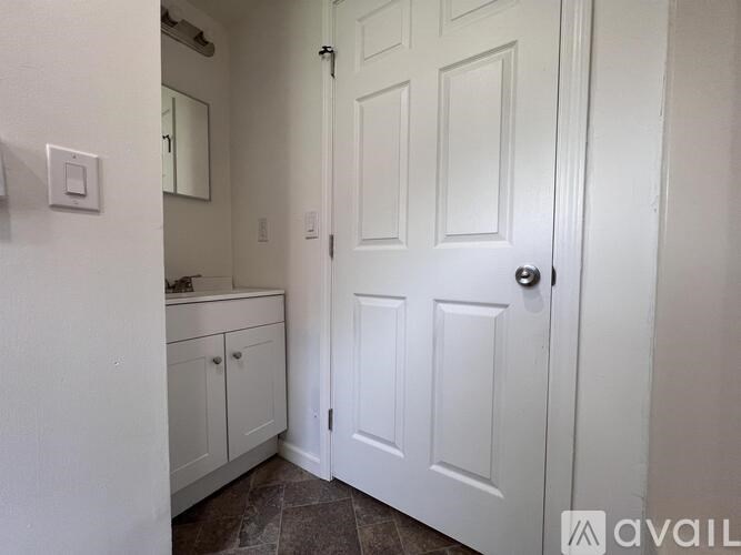 A white door is in a room with a tiled floor.