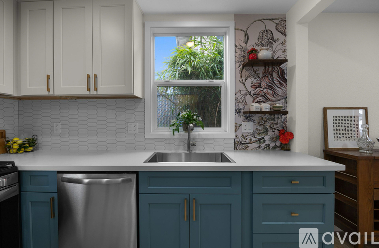 A kitchen with blue cabinets and a white countertop.
