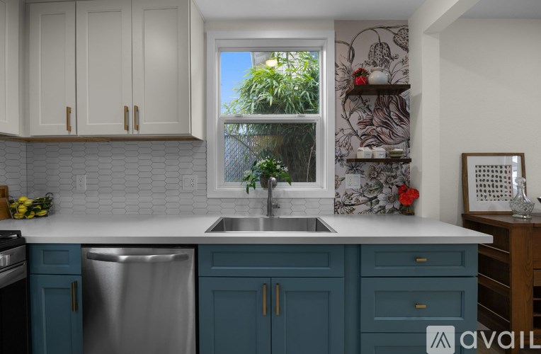 A kitchen with blue cabinets and a white countertop.