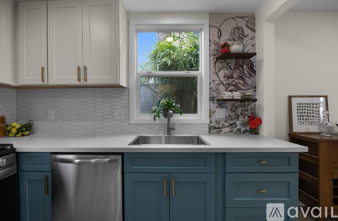 A kitchen with blue cabinets and a white countertop.